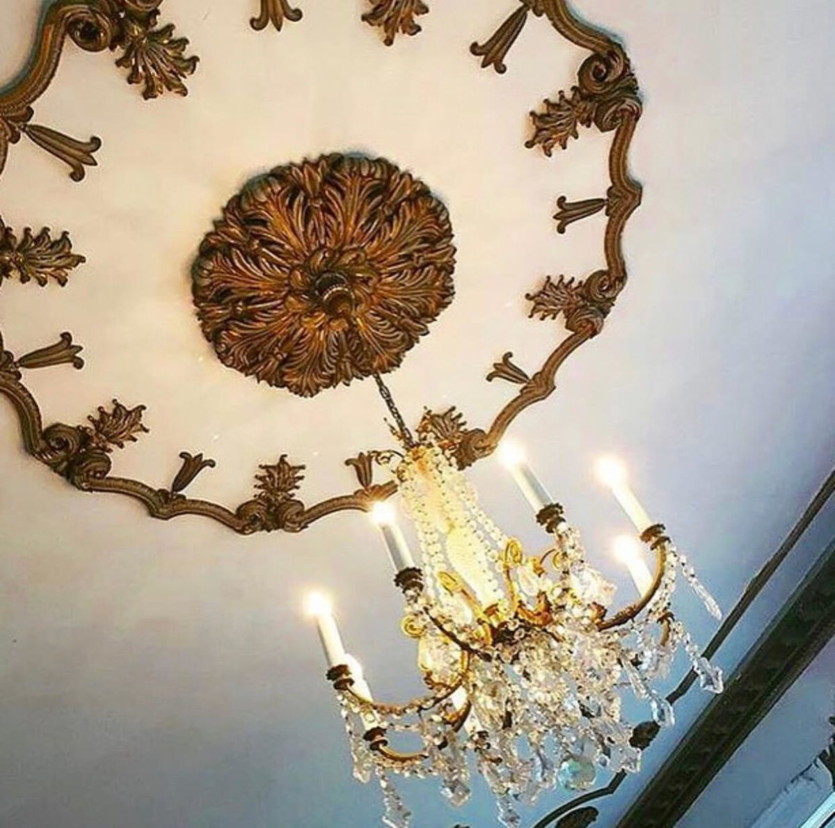 Bronze chandelier hanging from the ceiling