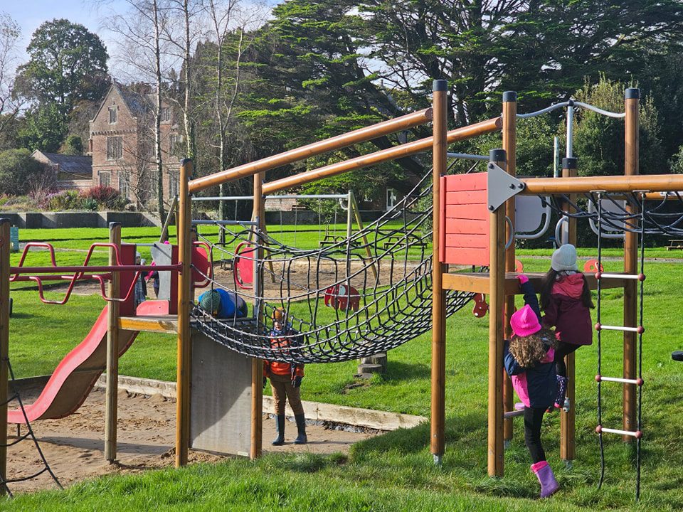 Children climbing on a climbing frame in the adventure playground at Wells House