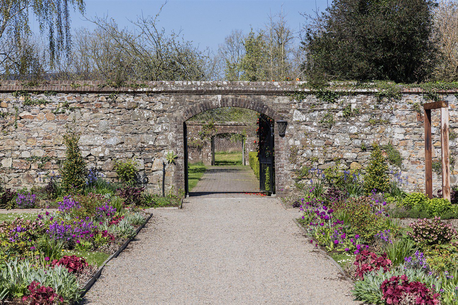 Wells House and Gardens 2025 Walled Garden Entrance Path through flowering borders leading to exit from he Walled Garden at Wells