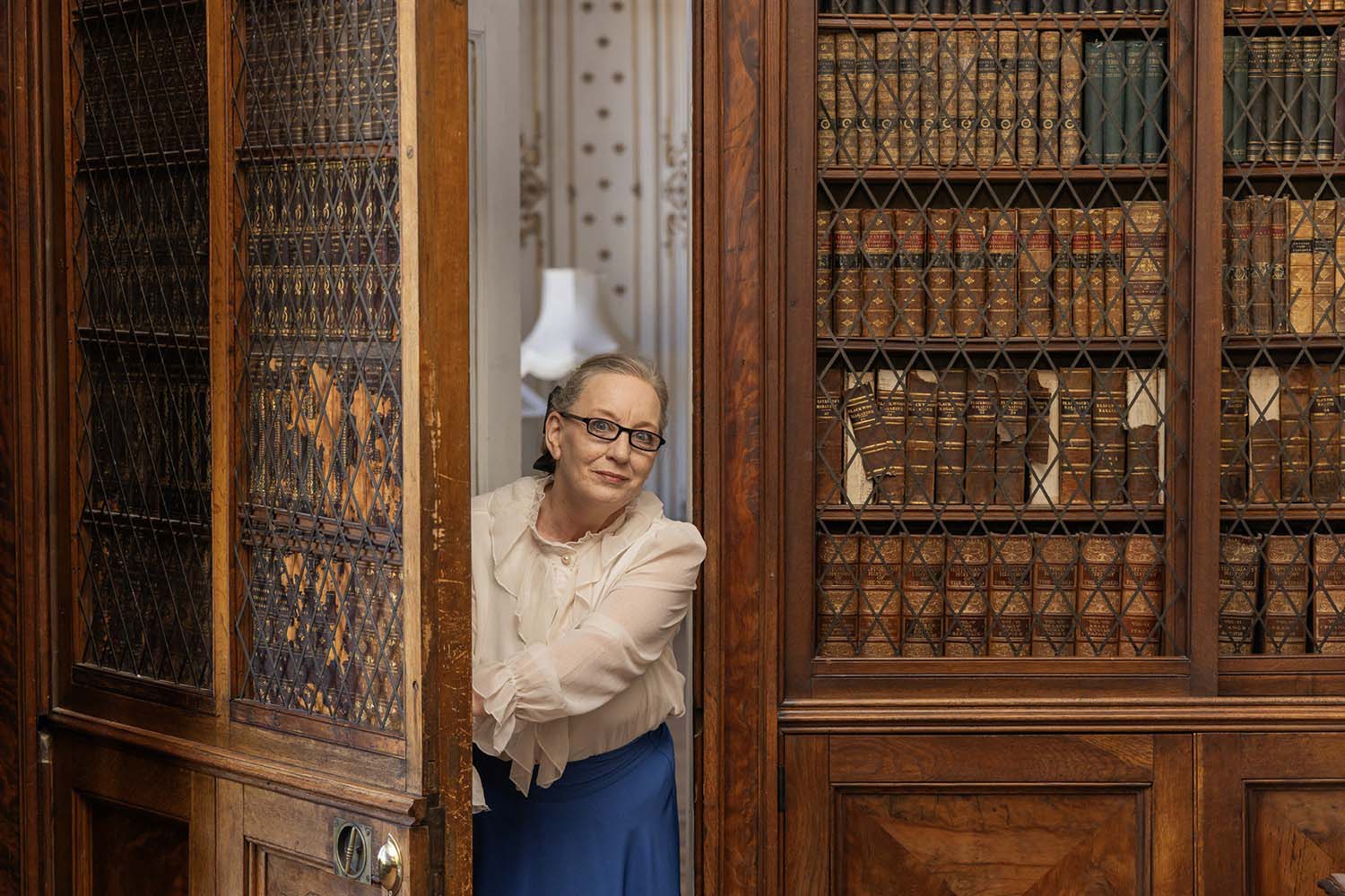 Costumed Tour Guide opening the door of the library